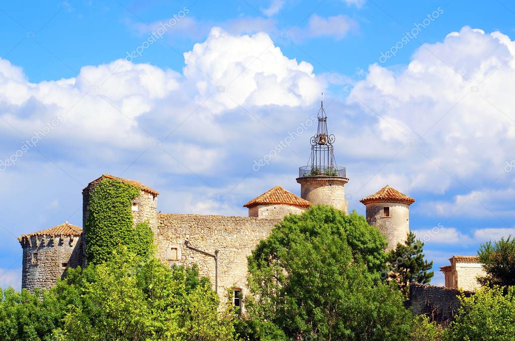 Roofs of the castle of Lussan on summer sky in Gard in Occitanie,                   