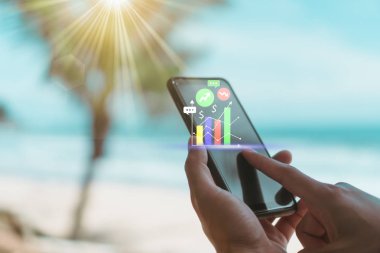 Kadın el iş, mali veya Ticaret hisse senedi forex piyasası ile plaj doğa arka plan yapmak için Smartphone veya tablet kullanarak