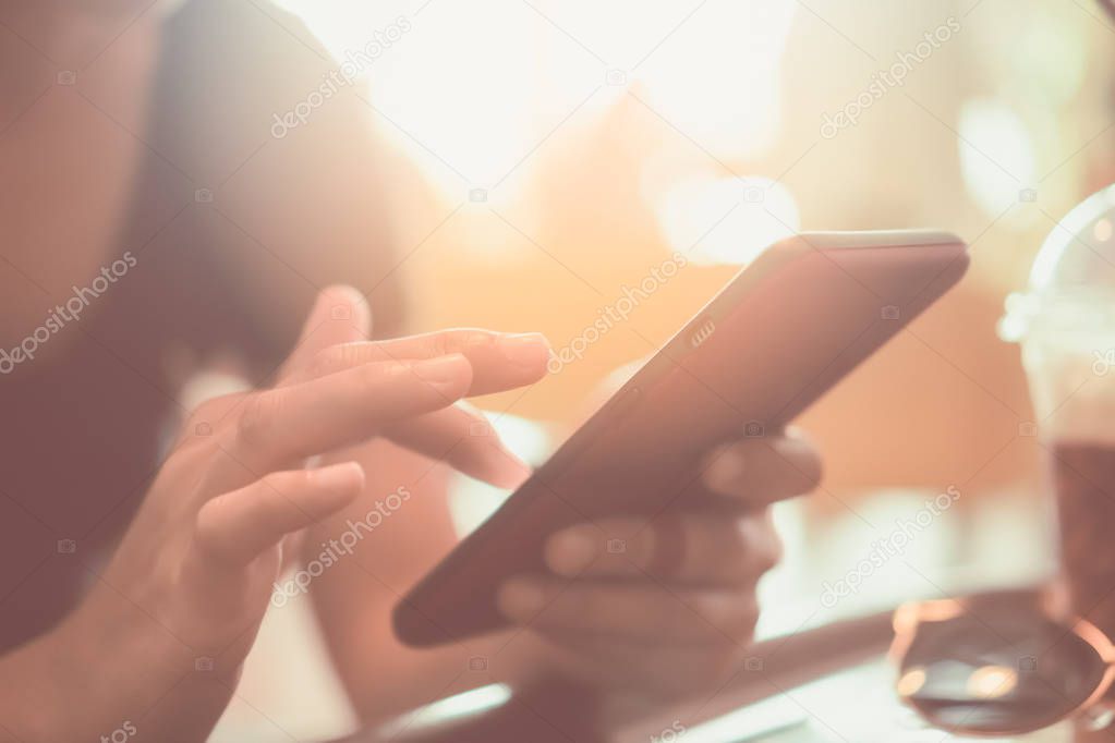 Woman hand using smartphone or tablet to do business, financial social network  with mountain view nature background