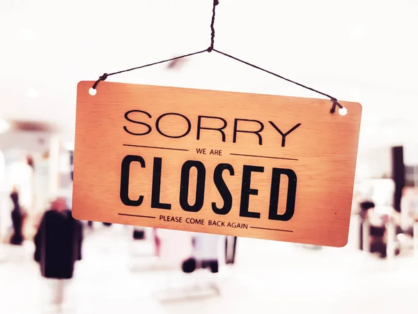 Sorry we are closed sign hang on door at coffee shop.