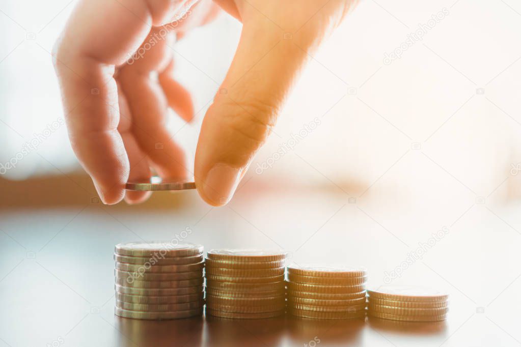 Business financial success concept. Gold coins on table and green nature bokeh background.Bullish market situation.