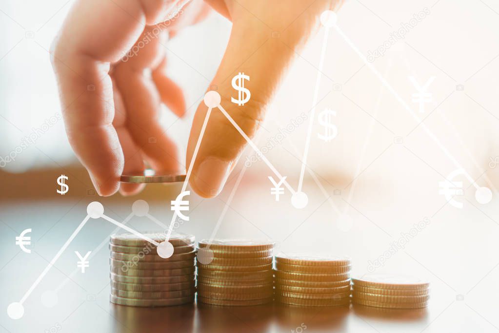 Business financial success concept with currency icon and graph double expose on picture. Gold coins on table and green nature bokeh background.Bullish market situation.