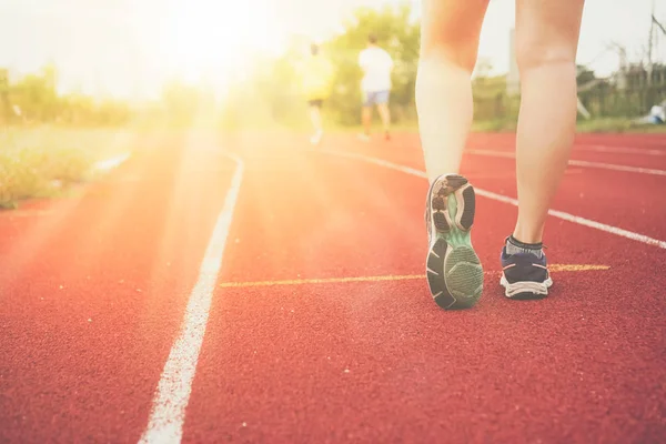 Woman wear sport shoe on to run in running court background. Health exercise life style concept.