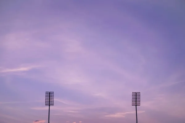 Stadium lighting on twilight colorful sky background.