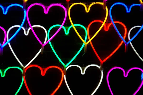 Heart light shape sparkle at night background.