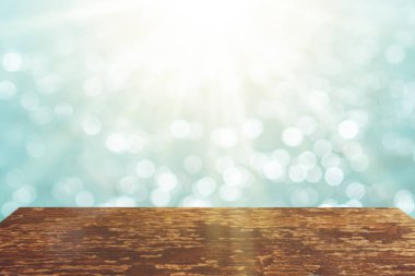 Ürününüzü göstermek için güzel plaj arka planına sahip eski ahşap masanın seçici odağı.