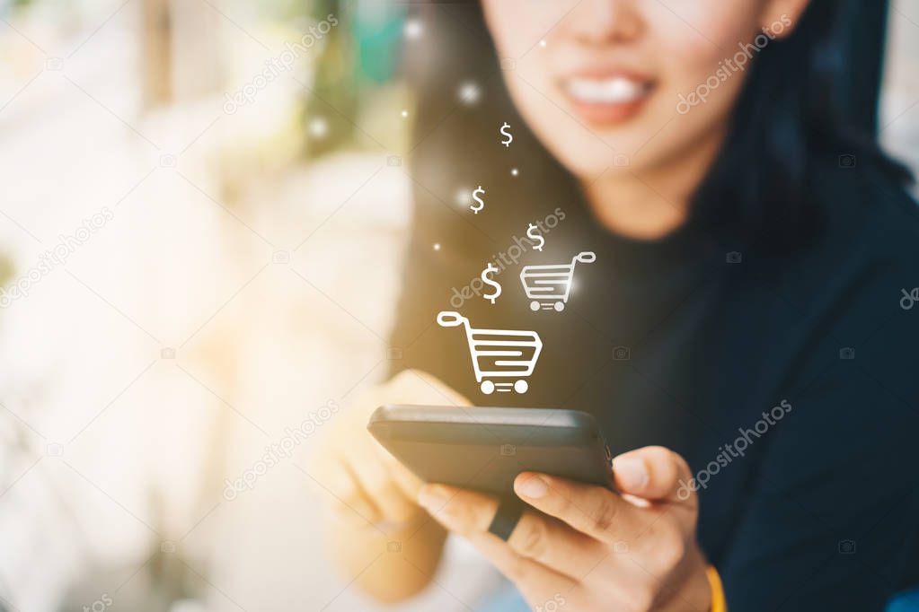 Women hand using smartphone do online selling for people shopping online in black friday with chat box, cart, dollar icons pop up. Social media maketing concept.