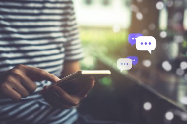 Kadınlar akıllı telefon daktiloyla yazı yazıp sohbet ediyorlar. Sohbet kutusu simgeleri ortaya çıkıyor. Sosyal medya teknolojisi kavramı. Klasik yumuşak renk tonu arkaplanı.