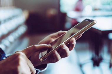Kadın el kafe salonu arka planda Smartphone kullanarak. İş, finans, Ticaret hisse senedi maket ve sosyal ağ kavramı.