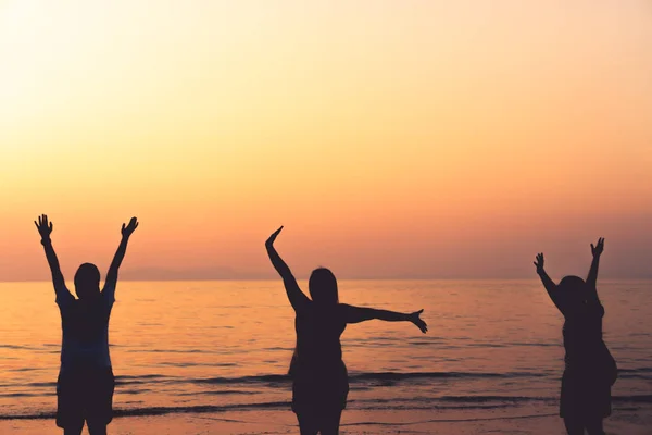 A group of womans rise hands up to sky freedom concept with blue sky and beach background. — Stock Photo, Image