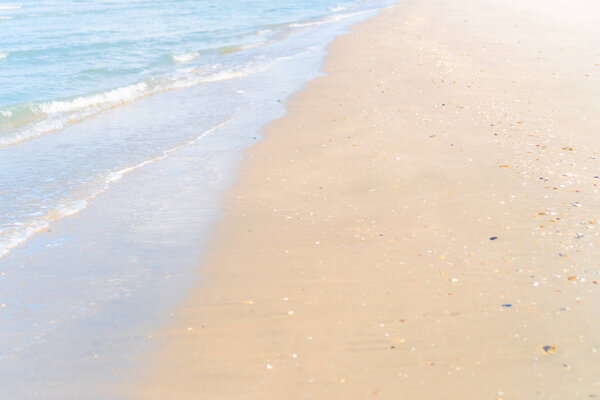 Tropical nature clean beach and white sand in summer with sun light blue sky and bokeh background.