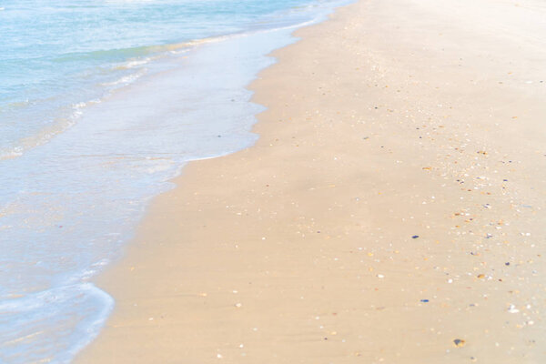 Tropical nature clean beach and white sand in summer with sun light blue sky and bokeh background.