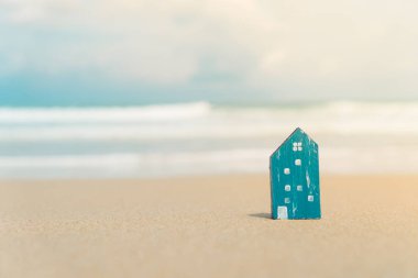 Güneş ışığı arka plan ile yeşil çim üzerinde küçük ev modeli kapalı.