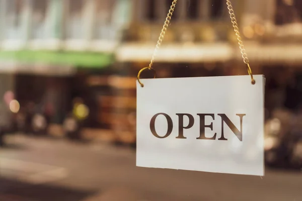 A business sign that says open on cafe or restaurant hang on door at entrance. Vintage color tone style. — Stock Photo, Image