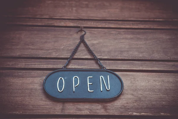 A business sign that says open on cafe or restaurant hang on door at entrance. Vintage color tone style. — Stock Photo, Image