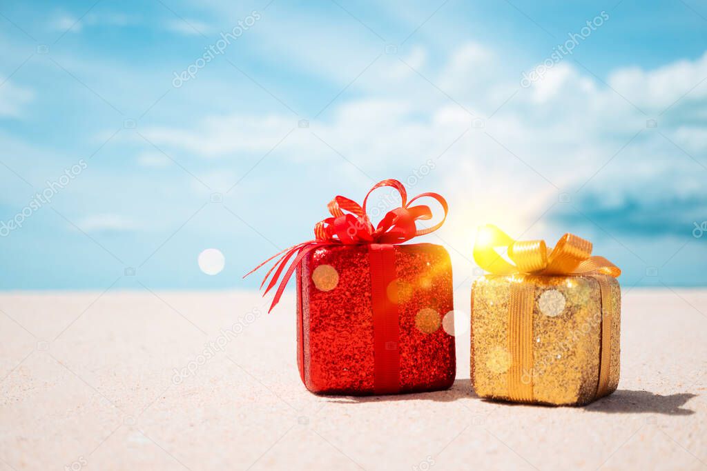 Gift boxes on sandy beach. Hot tours or holiday vacation concept with summer sea background.