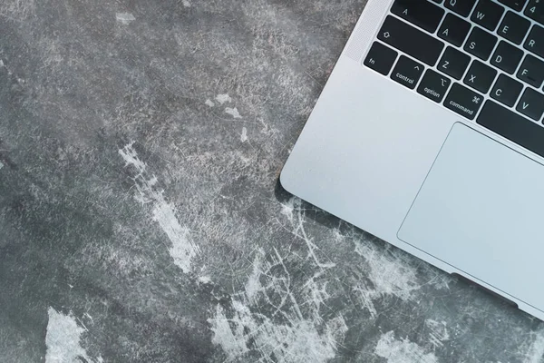 Top view of modern laptop or notebook with phone to work. Office desktop on table background.