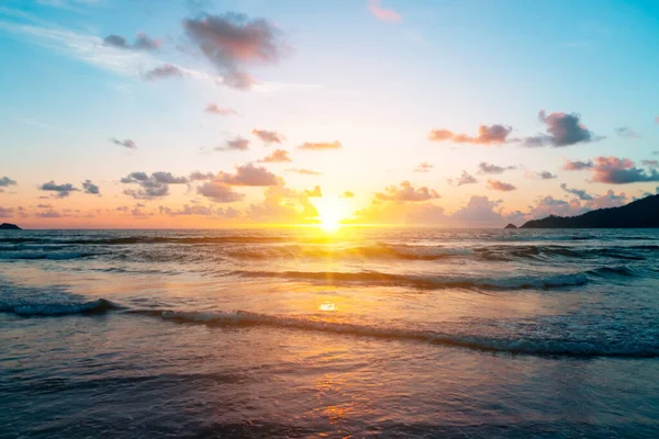 Yaz mevsiminde güneş doğarken ya da günbatımında ışık arka planda olan tropikal doğa denizi ya da plajı.