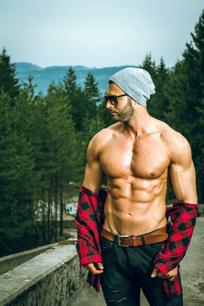 Handsome man wearing checked shirt outdoors — Stock Photo, Image