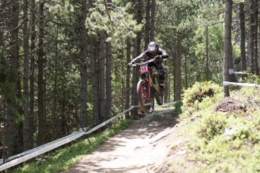 Vallnord, Andorra - 14 JULY 2018:  during his qualification race in the UCI Mountain Bike World Cup Downhill Vallnord 2018 clipart