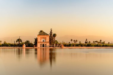 The Menara gardens are botanical gardens located to the west of Marrakech, Morocco, near the Atlas Mountains. clipart