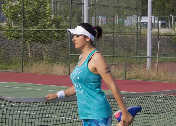 young woman on tennis court