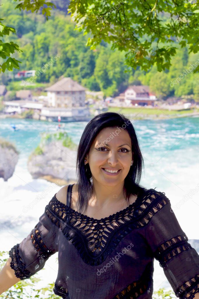 Beautiful young woman in rhine falls, Switzerland