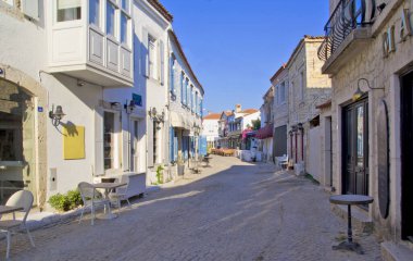 Alacati cesme, İzmir 'de dar bir sokakta renkli ve taştan evler