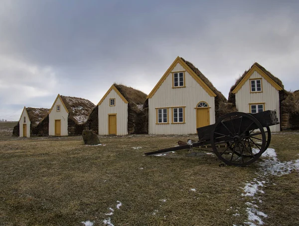 Uma velha carruagem em frente às casas de turfa — Fotografia de Stock