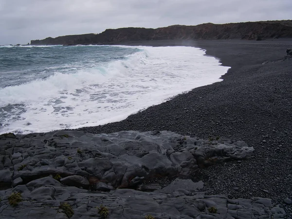 Waves at the black sandy beach of Djupalonssandur Stock Picture