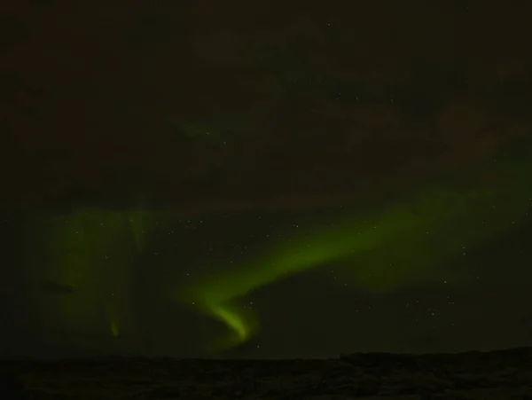 Landscape with northern lights behind clouds — Stock Photo, Image