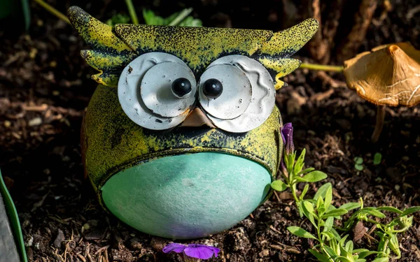 funny owl model statue in a garden close up decoration outdoor sunny