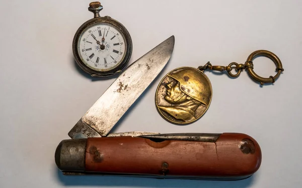 old soldier belongings vintage antique swiss military pocket knife with pocket clock and soldier emplem black background world war 2 leather surface