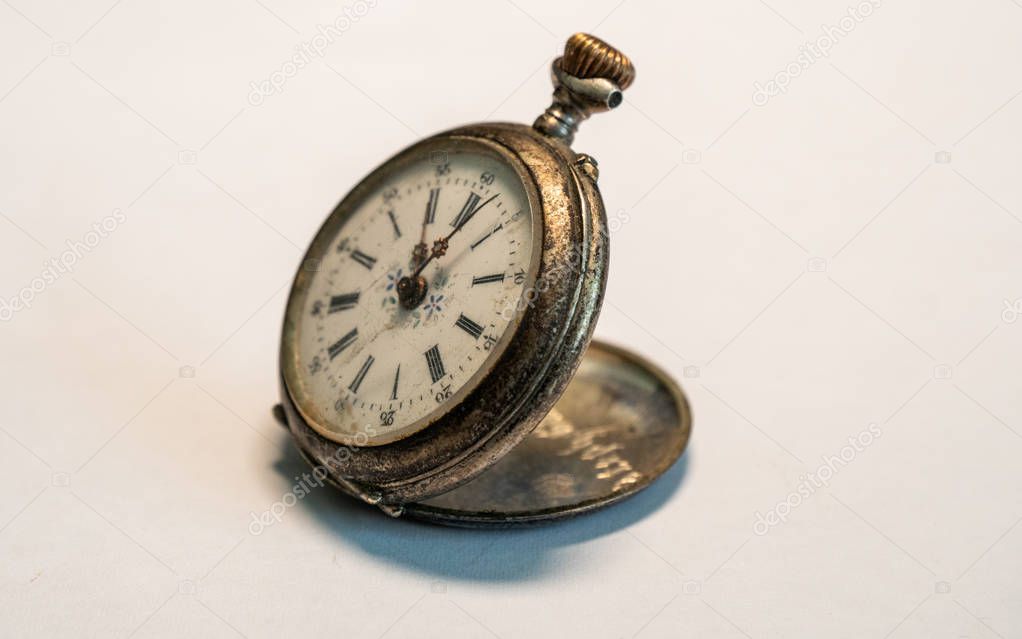 antique vintage pocket watch very old small watch rusty on white background studio light