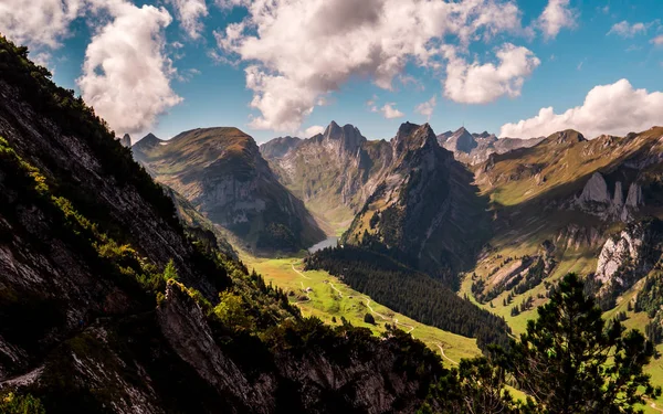 typical swiss mountain scenery with mountain lake during sunny summer day