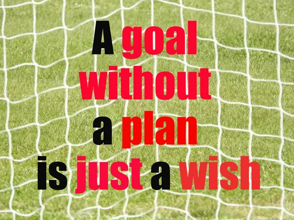 Soccer Goal Net and words A GOAL WITHOUT A PLAN IS JUST A WISH on Green Grass Background with selective focus and crop fragment. Business and motivation concept