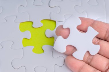 Parçalı bulmaca closeup görevi tamamlamak için son parçası elini. Seçici odak ve kırpma parçası