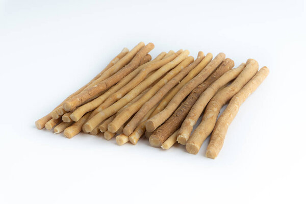 Natural toothbrush Miswak (Kayu Sugi) on white background with selective focus. It is a teeth cleaning twig made from the Salvadora persica tree and also know as miswaak, siwak, Sugi or sewak