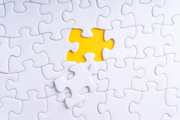 White jigsaw puzzle and missing pieces with selective focus and crop fragment