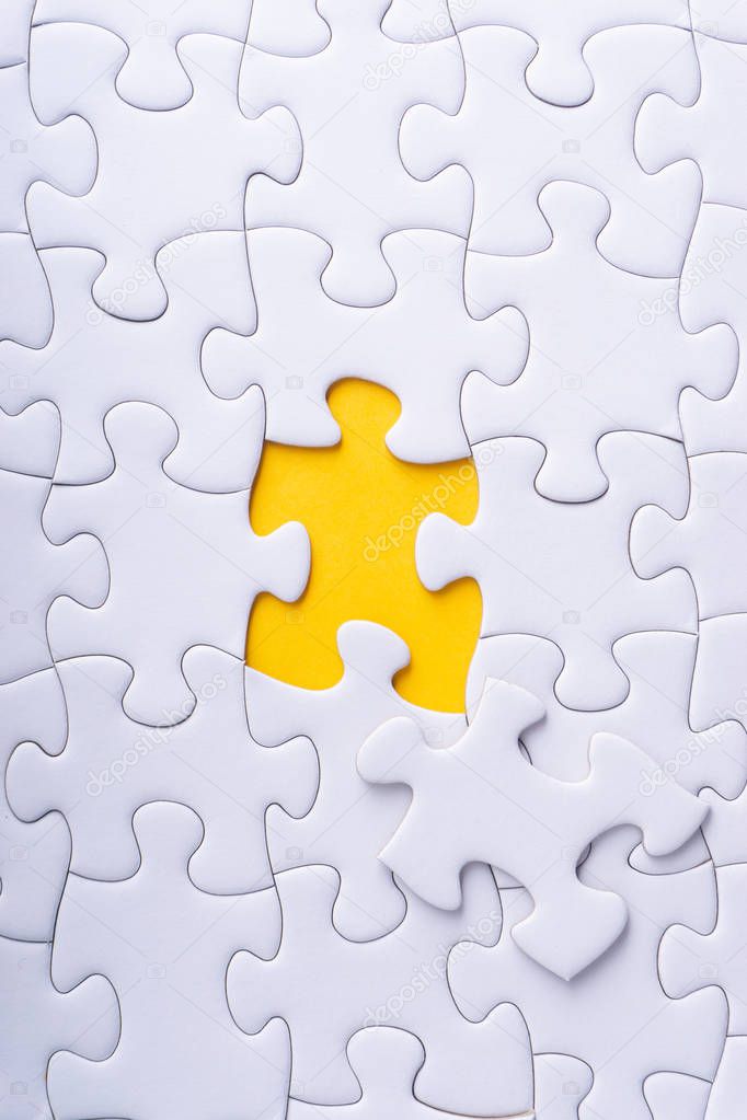 White jigsaw puzzle and missing pieces with selective focus and crop fragment