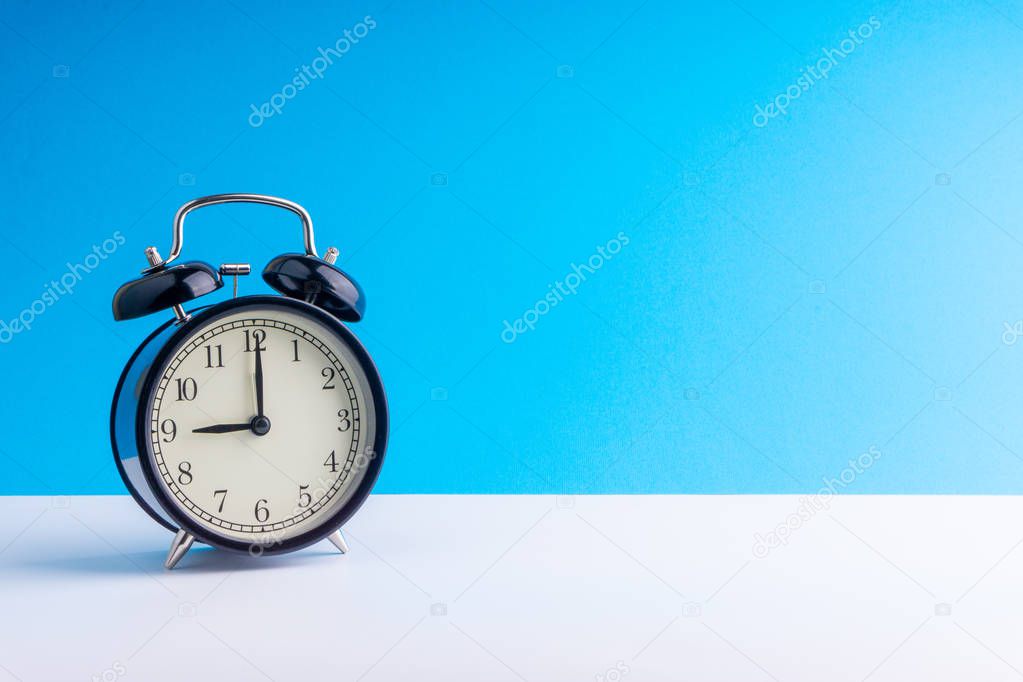 Alarm Clock on colorful background with selective focus and crop fragment. Copy space concept