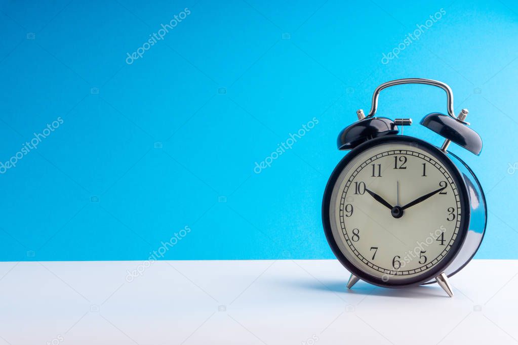 Alarm Clock on colorful background with selective focus and crop fragment. Copy space concept