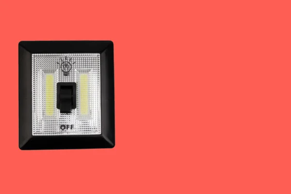 LED Light switch or Magnetic LED switch isolated on red background