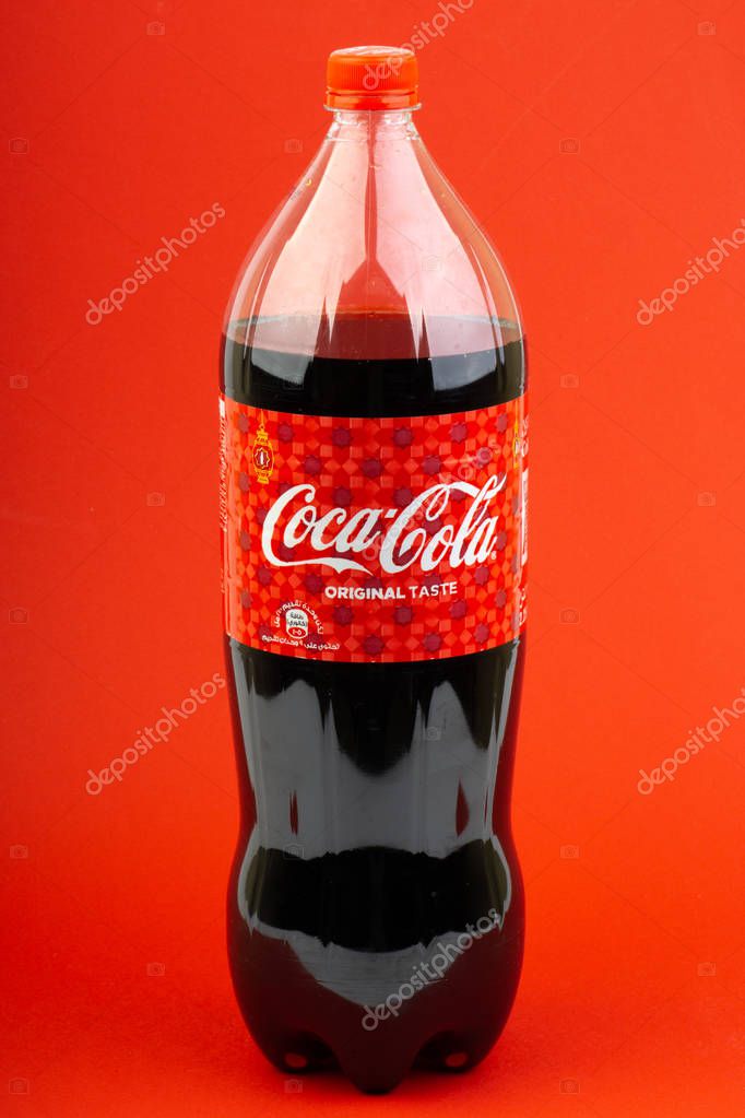 Kuala Lumpur, Malaysia - March 18,2019: Coca Cola Lantern edition bottle drink over a red  background with selective focus and crop fragment.