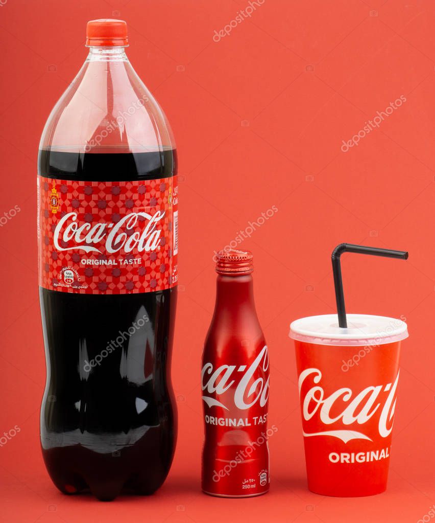Kuala Lumpur, Malaysia - March 18,2019: Coca Cola Lantern edition bottle drink over a red  background with selective focus and crop fragment.