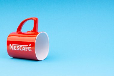 Kuala Lumpur, Malezya - 03 Temmuz 2019: Mavi arka plan üzerine promosyon kırmızı Nescafe kupa. Seçici odaklama