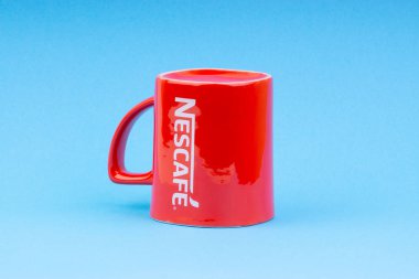 Kuala Lumpur, Malezya - 03 Temmuz 2019: Mavi arka plan üzerine promosyon kırmızı Nescafe kupa. Seçici odaklama