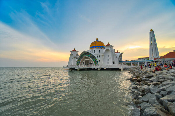 Kuala Lumpur, Malaysia - June 24, 2019: Beautiful sunset over the Malacca Straits Mosque or Masjid Selat. Selective focus