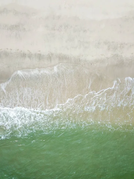 Blue ocean wave on clean sandy beach. Holidays and Travel Concept