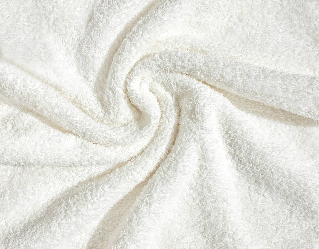 Towel texture close up. Terry cloth bath or beach towel. Soft fluffy textile. Top view. White towel macro material.